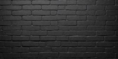 The primary subject of the image is a brick wall. The setting is a dark room, and the visual style is a black and white photo. The dominant colors are black and white, creating a moody atmosphere.