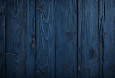 The primary subject of the image is a wooden wall with a blue tint. The setting is a room with a wooden floor. The visual style is a close-up of the wooden wall, showcasing its texture and grain. The colors and mood of the image are predominantly blue, creating a calm and serene atmosphere.
