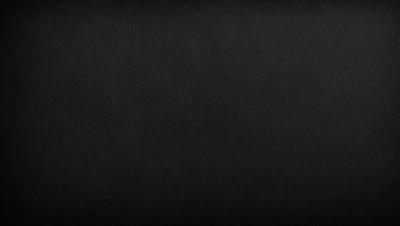 The image is a black and white photo of a black background.