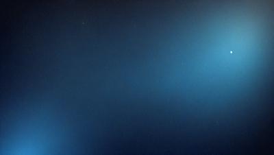 The primary subject of the image is a dark blue sky with a few stars visible. The setting is a vast, open space with no landmarks or objects in the background. The visual style is a realistic representation of the night sky, with no digital manipulation or artistic elements. The colors and mood of the image are predominantly dark and serene, with the blue sky and stars creating a sense of tranquility and vastness.