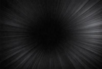 The primary subject of the image is a black circle, which appears to be a hole in the center of a black background. The setting is a dark, possibly industrial, environment. The visual style is a close-up of the black circle, with no other objects or details visible. The colors and mood are predominantly dark and moody, with the black circle being the focal point of the image.
