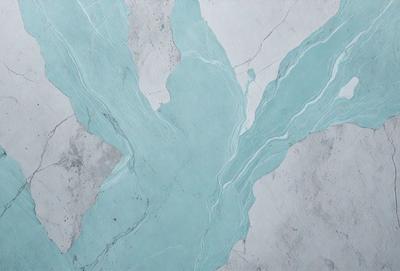 The primary subject of the image is a marble wall with a blue and white pattern. The setting is a room with a white marble surface. The visual style is a close-up of the marble wall, showcasing its intricate design. The colors and mood of the image are predominantly blue and white, creating a serene and elegant atmosphere.