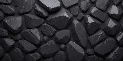 The primary subject of the image is a large black rock wall. The setting is a dark, possibly black, background. The visual style is a close-up of the rock wall, showcasing the intricate details of the rocks. The colors and mood of the image are predominantly dark, creating a moody and dramatic atmosphere.