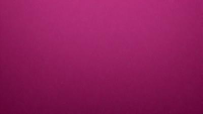 The primary subject of the image is a pink background. The setting is a close-up of the pink background, which appears to be a wall or a piece of fabric. The visual style is a close-up of the pink background, which gives a sense of depth and texture to the image. The colors and mood of the image are predominantly pink, creating a warm and inviting atmosphere.