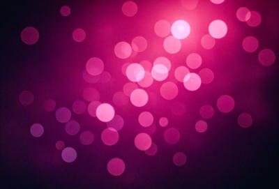 The primary subject of the image is a bright pink background with a pattern of pink dots. The setting is a dark background, which contrasts with the bright pink dots. The visual style is a close-up of the pink dots, creating a visually striking and vibrant scene. The colors and mood of the image are predominantly pink, creating a warm and lively atmosphere.
