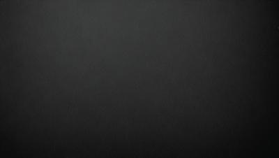 The primary subject of the image is a black background. The setting is a dark, empty space with no visible objects or elements. The visual style is a simple, monochromatic design. The colors and mood are predominantly dark and moody, creating a sense of mystery or drama.