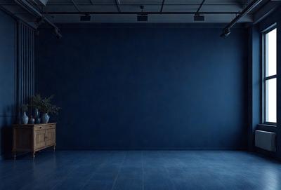 The primary subject of the image is a large, empty room with a blue wall. The setting is a dark room with a blue wall, and the visual style is a photo. The room appears to be a large, empty space with a blue wall, and the overall atmosphere is calm and quiet.