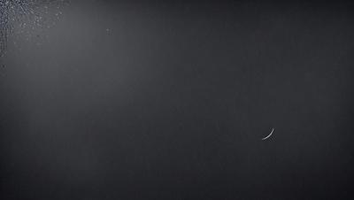 The primary subject of the image is a black background with a crescent moon visible in the upper right corner. The setting is a dark, starry sky, and the visual style is a black and white photo. The colors and mood of the image are predominantly dark and moody, with the crescent moon being the only bright spot in the scene.
