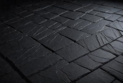 The primary subject of the image is a black tile floor. The setting is a dark room, and the visual style is a close-up of the floor. The colors and mood of the image are dark and moody, with the black tile floor being the main focus.