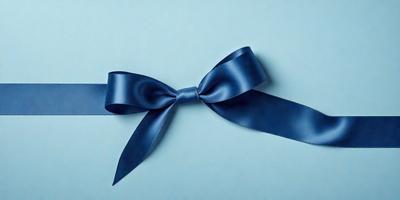 The primary subject of the image is a blue bow. The setting is a blue background, which creates a contrast with the bow. The visual style is a close-up of the bow, showcasing its details. The colors and mood of the image are predominantly blue, giving it a calm and serene atmosphere.
