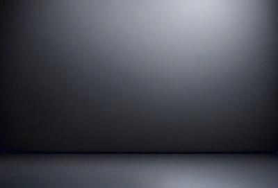 The primary subject of the image is a large, empty room with a gray wall. The setting is a dark room, possibly a basement, with a black background. The visual style is a black and white photo, giving the image a classic and timeless appearance. The colors and mood are predominantly dark and moody, creating a sense of mystery and solitude.