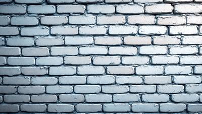 The primary subject of the image is a brick wall. The setting is a brick wall with a blue background. The visual style is a photo of a brick wall. The colors and mood of the image are predominantly blue, giving it a calm and serene atmosphere.