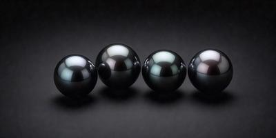 The image features a row of six black spheres, likely black pearls, arranged in a neat line. The setting is a dark background, which contrasts with the brightness of the pearls. The visual style appears to be a close-up of the pearls, showcasing their unique shapes and textures. The overall atmosphere is elegant and sophisticated, with the black pearls serving as the primary subject of the image.