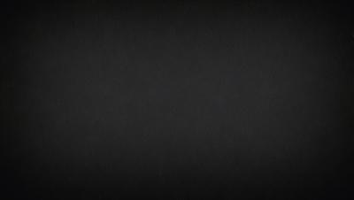 The image is a black and white photo of a dark background.