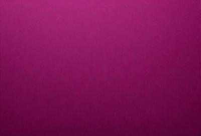 The primary subject of the image is a large, purple wall. The setting is a room with a pink background. The visual style is a close-up of the wall, which gives a sense of depth and texture. The dominant colors are purple and pink, creating a warm and inviting atmosphere.