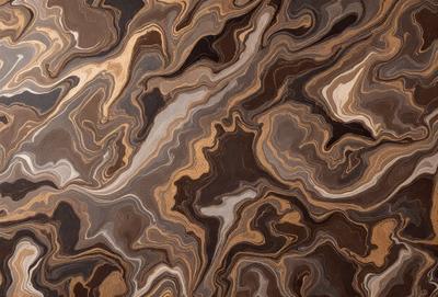 The primary subject of the image is a close-up of a marble-like pattern, which appears to be a wood grain texture. The setting is a wooden surface, and the visual style is a close-up of the pattern. The colors and mood of the image are predominantly brown, giving it a warm and natural appearance.