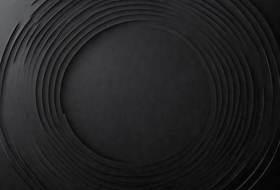 The primary subject of the image is a black and white circle. The setting is a black background, and the visual style appears to be a photo. The colors and mood of the image are predominantly dark and moody, with the black circle being the focal point.