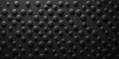 The primary subject of the image is a black background with a pattern of round circles. The circles are of various sizes and are arranged in a visually appealing manner. The setting is a dark room, and the visual style is a combination of a photo and a pattern. The dominant colors are black and white, and the overall atmosphere is one of simplicity and elegance.