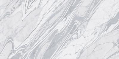 The primary subject of the image is a marble tile with a patterned design. The setting is a bathroom, as indicated by the presence of the marble tile. The visual style is a close-up of the tile, showcasing its intricate pattern. The colors and mood of the image are predominantly white, giving it a clean and elegant appearance.