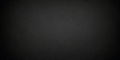 The primary subject of the image is a black background. The setting is a dark, empty space with no visible objects or elements. The visual style is a black and white photo, which gives the image a classic and timeless appearance. The colors and mood are predominantly dark and moody, creating a sense of mystery and depth.