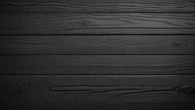 The primary subject of the image is a wooden wall. The setting is a black background, which creates a striking contrast with the wooden surface. The visual style is a close-up of the wooden wall, showcasing its texture and details. The colors and mood of the image are predominantly black, giving it a bold and dramatic appearance.