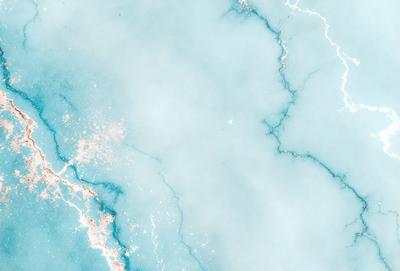The primary subject of the image is a blue marble wall with a cracked texture. The setting is a dark room, and the visual style is a photo. The dominant colors are blue and black, creating a moody atmosphere.