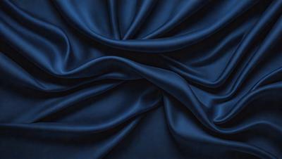 The primary subject of the image is a blue fabric, which is the main object, scene, or focus of the image. The setting or background is a blue cloth, and the visual style is a photo. The dominant colors and overall atmosphere are blue and dark, creating a moody and dramatic scene.