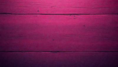 The primary subject of the image is a wooden wall with a pinkish hue. The setting is a room with a wooden floor. The visual style is a close-up of the wooden wall, which gives a sense of texture and warmth. The dominant colors are pink and brown, creating a cozy and inviting atmosphere.