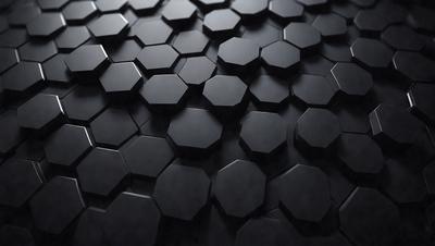 The primary subject of the image is a close-up of a black and white patterned surface, which appears to be a textured wall or a black and white checkered floor. The setting is a dark room, and the visual style is a black and white photo. The dominant colors are black and white, and the overall atmosphere is somewhat mysterious and intriguing.