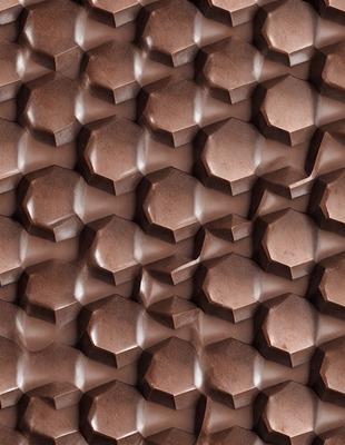The primary subject of the image is a close-up of a brown, textured surface, which appears to be a patterned wall or a piece of fabric. The setting is indoors, with the surface being the main focus of the image. The visual style is a close-up, which emphasizes the intricate details of the surface. The colors and mood of the image are warm and earthy, with the brown tones creating a cozy and inviting atmosphere.