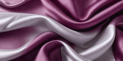 The primary subject of the image is a close-up of a purple and white fabric. The setting is a room with a purple background, and the visual style is a photo. The dominant colors in the image are purple and white, creating a calm and elegant atmosphere.