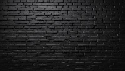 The primary subject of the image is a black brick wall. The setting is a dark room, and the visual style is a black and white photo. The dominant colors are black and white, creating a moody atmosphere.