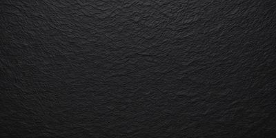 The primary subject of the image is a black leather material, which appears to be a leather-like fabric or a leather-like wallpaper. The setting is a black background, which contrasts with the leather material. The visual style is a close-up of the leather material, showcasing its texture and appearance. The colors and mood of the image are predominantly black, giving it a sleek and modern look.
