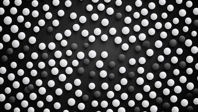The primary subject of the image is a pattern of white and black dots. The setting is a black background, which contrasts with the white dots. The visual style is a combination of digital art and illustration, creating a unique and eye-catching design. The colors and mood of the image are predominantly black and white, giving it a modern and minimalist appearance.