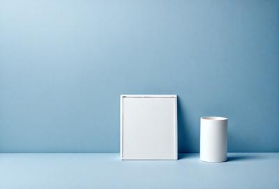 The primary subject of the image is a white box, which is placed on a blue surface. The setting appears to be a room with a blue wall, and the visual style is a photo. The colors and mood of the image are predominantly blue, creating a calm and serene atmosphere.