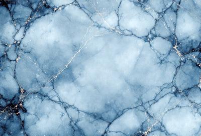 The primary subject of the image is a blue and white marbled surface, which appears to be a wall or a piece of art. The setting is a room with a blue and white marbled wall, and the visual style is a close-up of the marbled surface. The colors and mood of the image are predominantly blue and white, creating a calm and serene atmosphere.
