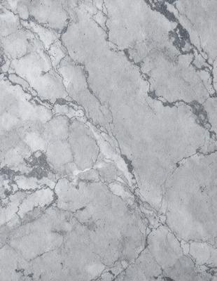 The image features a marble surface with a pattern of holes and grooves. The marble appears to be grey in color, and the surface is textured, giving it a unique and natural appearance. The setting is a close-up of the marble surface, showcasing its intricate details and patterns. The visual style of the image is a close-up of the marble, emphasizing its texture and pattern. The colors and mood of the image are predominantly grey, giving it a calm and sophisticated atmosphere.