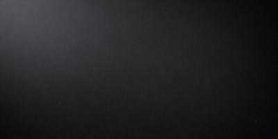The primary subject of the image is a black background. The setting is a dark room, and the visual style is a black and white photo. The colors and mood of the image are predominantly dark and moody, with a sense of mystery and depth.