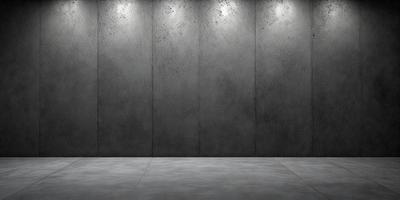 The primary subject of the image is a large, gray concrete wall. The setting is a room with a concrete floor, and the visual style is a photo. The dominant colors are gray and black, creating a stark and minimalist atmosphere.