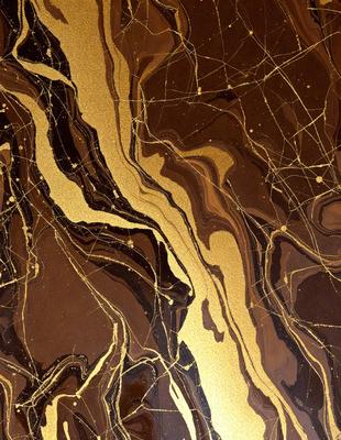The primary subject of the image is a marble countertop with a gold-colored pattern. The setting is a kitchen, and the visual style is a close-up of the marble countertop. The colors and mood of the image are warm and luxurious, with the gold pattern adding a touch of sophistication.