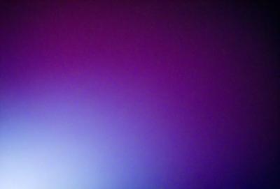 The primary subject of the image is a purple wall. The setting is a room with a purple wall, and the visual style is a photo. The dominant colors in the image are purple and blue, creating a calm and serene atmosphere.