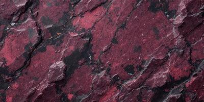 The primary subject of the image is a large, red rock with a pattern of red and black. The rock is the main object, scene, or focus of the image. The setting or background consists of a dark, rocky surface, which adds to the overall atmosphere of the image. The visual style of the image is a close-up of the rock, showcasing its unique pattern. The colors and mood of the image are predominantly dark and moody, with the red and black pattern on the rock standing out against the dark background.