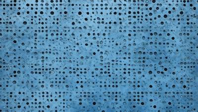 The primary subject of the image is a blue surface with a pattern of holes. The setting is a blue wall, and the visual style appears to be a photo. The dominant colors are blue and white, creating a calm and soothing atmosphere.
