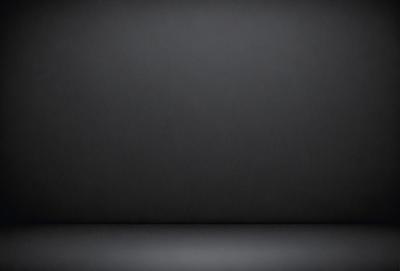 The primary subject of the image is a black background. The setting is a dark room, and the visual style is a black and white photo. The colors and mood of the image are predominantly dark and moody.
