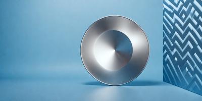 The primary subject of the image is a silver bowl or dish, which is placed on a blue surface. The visual style of the image is a photo, and the colors and mood are predominantly blue and calm.