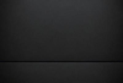 The primary subject of the image is a black leather surface. The setting is a black background, and the visual style is a close-up of the leather surface. The colors and mood of the image are predominantly dark and moody, with the black leather creating a sense of depth and contrast.