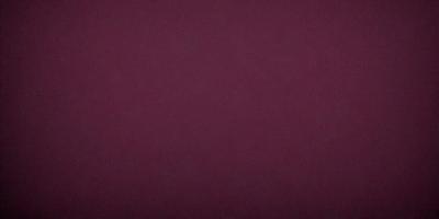 The primary subject of the image is a close-up of a maroon wall. The setting is indoors, with the wall being the main focus of the scene. The visual style appears to be a photo, as it captures the details of the wall. The dominant colors in the image are maroon and red, creating a warm and cozy atmosphere.