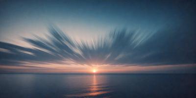The primary subject of the image is a beautiful sunset over the ocean. The sun is setting behind the clouds, creating a stunning backdrop. The setting is a vast body of water, with the sun's rays reflecting off the surface, creating a serene and calming atmosphere. The visual style of the image is a photo, capturing the natural beauty of the sunset and the ocean. The colors and mood of the image are predominantly warm and soothing, with the sun's hues and the ocean's tranquility creating a peaceful and picturesque scene.
