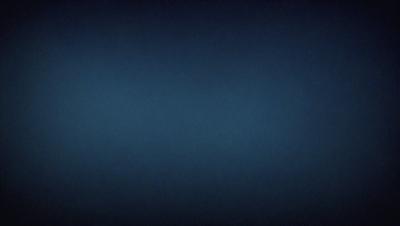 The primary subject of the image is a dark blue sky. The setting is a vast, open space with no visible landmarks or objects. The visual style is a natural, outdoor scene. The colors and mood are predominantly dark and moody, with the blue sky being the main focus of the image.