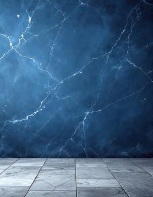 The primary subject of the image is a blue wall with a marble texture. The setting is a room with a tiled floor. The visual style is a photo of the wall, showcasing the unique marble pattern. The dominant colors are blue and white, creating a calm and serene atmosphere.
